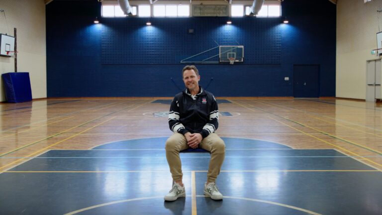 David Guest sitting in a gym